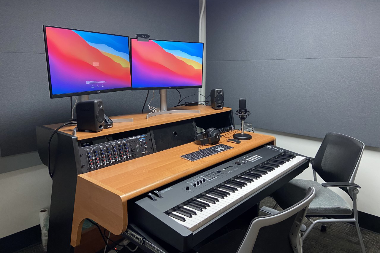 Piano keyboard and computer workstation in library media studio