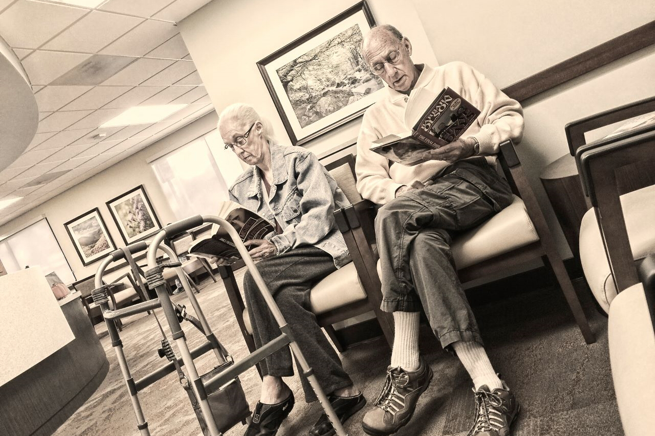 Two people in a medical office waiting room