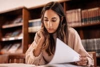 Student looking at study materials.