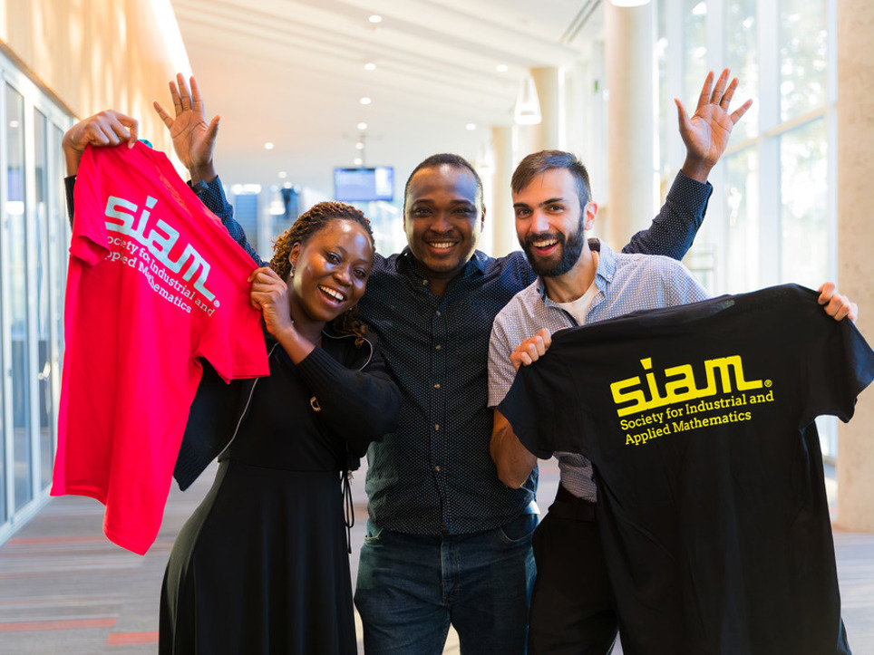 People holding us shirts with 'siam' on the front.